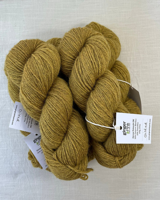 Skeins of soft golden yellow toned sustainable British DK wool naturally dyed with plants for knitting
