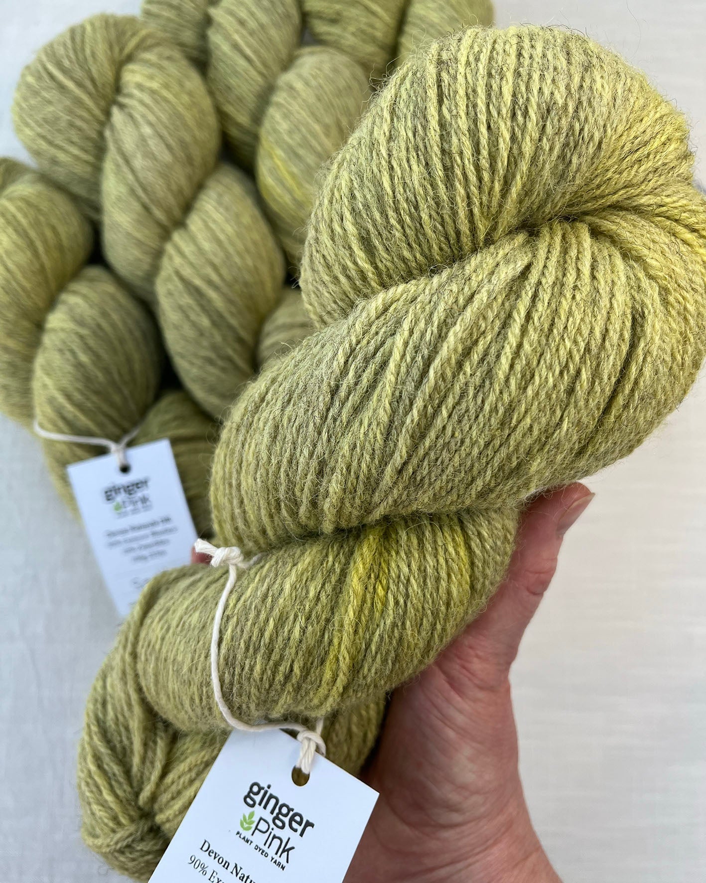 Skeins of soft Sorbet green and yellow toned sustainable British DK wool naturally dyed with plants