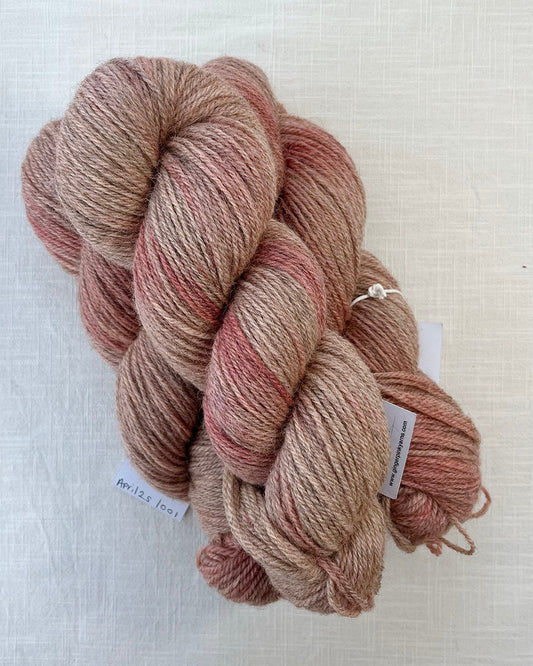 Skeins of soft pink toned semi-solid sustainable British DK wool naturally dyed with plants for knitting