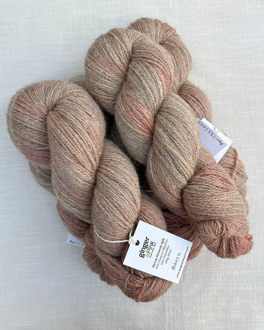 Skeins of soft pink toned sustainable British 4ply wool naturally dyed with plants for knitting