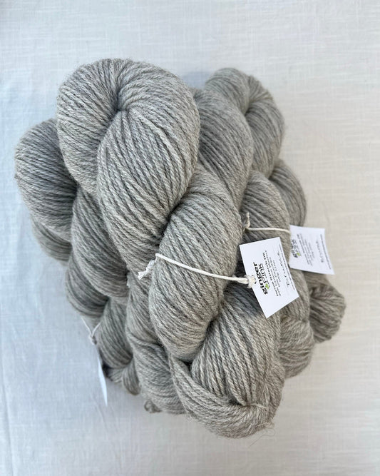 Skeins of soft grey toned sustainable British DK wool naturally dyed with plants