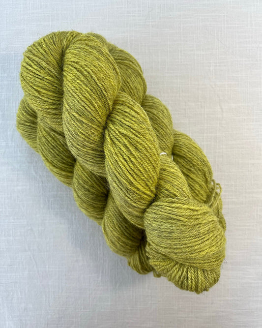 Skeins of soft chartreuse yellow toned sustainable British DK wool naturally dyed with plants